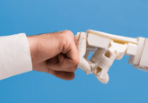 Image of two arms, one a man in a labcoat, one a robot, fistbumping. To show the concept of a new partnership to form a real-world data platform integrating AI and EMR