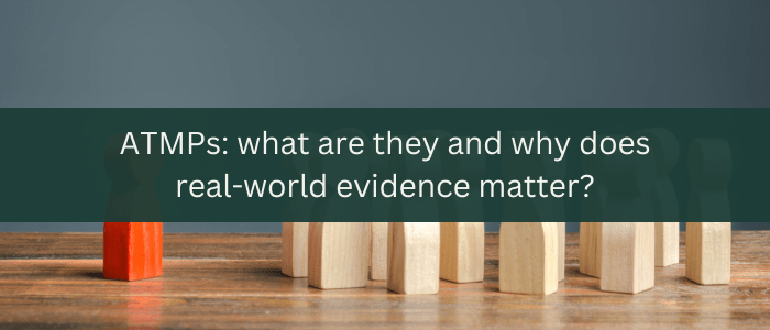 White text on a green banner, reading 'ATMPs: what are they and why does real-world evidence matter?'. Behind the banner are several plain wooden figures on a table, arranged so they are facing a lone wooden figure that has been painted red.