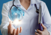 Woman in lab coat with stethoscope around her neck holds hologram of Earth in her hand. To represent that HMA and EMA introduce electronic catalogues of RWD sources and studies.