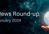 A hand holding a holographic globe on a dark background. To represent the concept of industry news updates from January 2024.