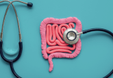 A stethoscope on a blue background 'listening' to pink fake intestines. To represent that Verantos launches Inflammatory Bowel Disease Pragmatic Registry.